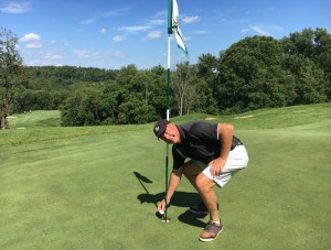 Alumnus Chris Freeman is shown just after he scored a hole-in-one on the ninth hole.