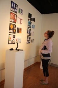 Lindsay Riggs looks at one of her artworks.