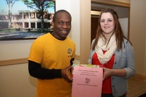 Nathan Johnson and Tara Adamzcyk are shown with one of the domestic violence collection boxes in Shaw Hall.