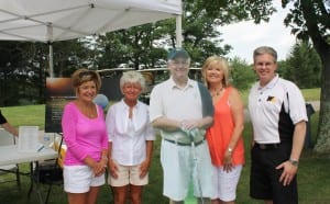 From left, Loew sisters Sharon Saseen and Brenda Thomas, Lary's companion Colleen Blon and Alumni Director Ron Witt pose with the life-size cardboard cutout of Lary.