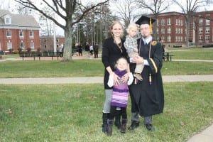 Student speaker Zachary Novel and his wife Jayme and children isaac and Erin celebrate on the quad.