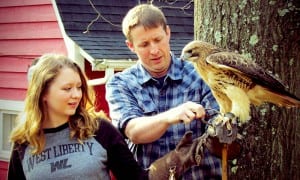 Joe Greathouse shows WLU student XXX how to handle a hawk at Good Zoo.