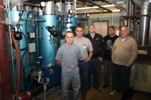 From left, Brooks XXX, Keith Kaczor, Patrick Kerns, Jonathon XXX and Mark Mangfico stand near the new boiler in Blatnik Gym.