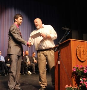 Adam Kenney is shown receiving his research award at Spring Convocation from Dr. Roger Seeber.