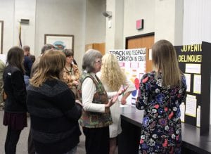 The poster session offers students a chance to explain and defend their thesis.
