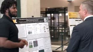Delano Marcelus shares his research on transcriptional profiling of bacteria with incoming WLU President Dr. Tim Borchers.