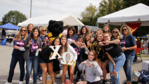 Topper Bear with Students at Homecoming