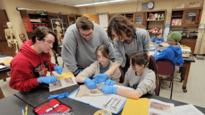 Lydia Grubbs, Benjamin Hensley, Denny Belli, Laiken Houchins and Sierra Houchins examine one of the brain dissections.