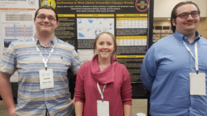 Jason Ake, Liz Burkey, and Loyd Butcher in front of one of their poster presentations (MS, Sr BS, Sr BS)