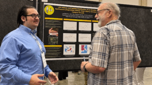 Jason Ake discussing his research at the poster presentation exhibits