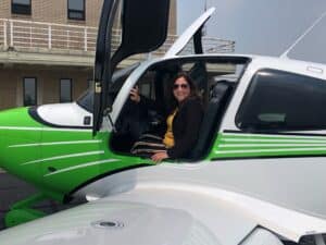 West Liberty Registrar Stephanie North prepares for a flight in a Marshall airplane at last summer’s announcement of the partnership between the two Universities to start a joint aviation program.