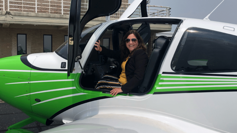 West Liberty Registrar Stephanie North prepares for a flight in a Marshall airplane at last summer’s announcement of the partnership between the two Universities to start a joint aviation program.